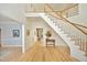 Bright foyer featuring hardwood floors, an elegant staircase, and hallway views with natural light at 107 Silo Dr, Chapel Hill, NC 27514