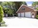 Large three car garage is detached with brick exterior and large driveway at 107 Silo Dr, Chapel Hill, NC 27514