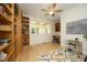 Well-lit home office with custom built-in shelves, light hardwood floors and windows at 107 Silo Dr, Chapel Hill, NC 27514