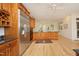 Spacious kitchen features stainless steel refrigerator, beautiful wood cabinets, and granite countertops at 107 Silo Dr, Chapel Hill, NC 27514