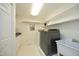 Bright laundry room features modern washer, dryer, sink, shelving, and ample storage at 107 Silo Dr, Chapel Hill, NC 27514