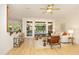 Cozy living room with a bar area, hardwood floors, and seamless access to the sunroom at 107 Silo Dr, Chapel Hill, NC 27514