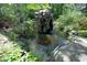 Scenic backyard pond with a fountain feature and lush green landscaping creating a tranquil atmosphere at 107 Silo Dr, Chapel Hill, NC 27514