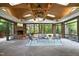 Spacious sunroom with a stone fireplace, skylights, and walls of windows offering nature views at 107 Silo Dr, Chapel Hill, NC 27514