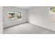 Carpeted bedroom with two windows offering exterior views at 109 Gladstone Loop, Clayton, NC 27520