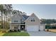 Charming two-story home with a three car garage and well-manicured lawn at 11 Little Gem Ln, Fuquay Varina, NC 27526
