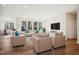 Bright living room with hardwood floors, modern furnishings, and large windows at 11 Little Gem Ln, Fuquay Varina, NC 27526