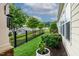 Backyard features manicured landscaping, secure fencing, and lush green lawn at 112 Tanoak Ct, Durham, NC 27703