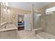 Bright bathroom featuring double sinks with granite countertops, a glass shower, and a view to the bedroom at 112 Tanoak Ct, Durham, NC 27703