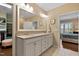 Bright bathroom featuring double sinks, granite countertops, and walk-in closet access at 112 Tanoak Ct, Durham, NC 27703