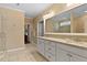 Well-lit bathroom featuring double sinks with granite countertops and a glass enclosed shower at 112 Tanoak Ct, Durham, NC 27703