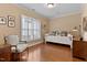 Relaxing bedroom with neutral walls, plantation shutters, and stylish hardwood flooring at 112 Tanoak Ct, Durham, NC 27703