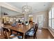 Open dining room with elegant chandelier, hardwood floors, and views to the living spaces at 112 Tanoak Ct, Durham, NC 27703