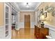Elegant foyer featuring hardwood floors, paneled walls, and a decorative chest at 112 Tanoak Ct, Durham, NC 27703