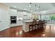 Modern kitchen boasts a large island with seating and stainless steel appliances at 112 Tanoak Ct, Durham, NC 27703