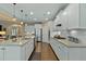 Open concept kitchen with white cabinets, granite countertops, and stainless steel appliances at 112 Tanoak Ct, Durham, NC 27703