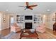 Comfortable seating area with a fireplace and built-in shelving on either side at 112 Tanoak Ct, Durham, NC 27703