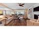 Bright living room with fireplace, custom built-ins, and hardwood flooring and view into dining area at 112 Tanoak Ct, Durham, NC 27703