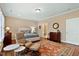 Well lit main bedroom featuring wood floors, a sitting area, and a luxurious upholstered bed at 112 Tanoak Ct, Durham, NC 27703