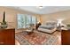 Spacious main bedroom with a large window, hardwood floors, and elegant furnishings at 112 Tanoak Ct, Durham, NC 27703