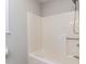 A clean and simple bathtub with shower fixture and neutral-toned surround at 113 Honeysuckle Ln, Durham, NC 27703