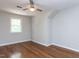 Bedroom featuring wood floors, a ceiling fan, and a window for natural light at 113 Honeysuckle Ln, Durham, NC 27703