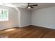 Bedroom features wood floors, a ceiling fan, and a window for natural light at 113 Honeysuckle Ln, Durham, NC 27703