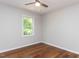 Simple bedroom featuring hardwood floors, a large window, and neutral paint at 113 Honeysuckle Ln, Durham, NC 27703