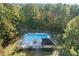 Aerial view of a community pool featuring lounge chairs and surrounded by lush greenery and trees at 113 Honeysuckle Ln, Durham, NC 27703