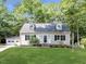 Charming one story home with manicured lawn, dormer windows, and a detached two car garage at 113 Honeysuckle Ln, Durham, NC 27703