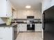 Updated kitchen featuring white cabinets, stainless steel appliances, and tiled floors at 113 Honeysuckle Ln, Durham, NC 27703