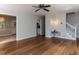 Open-concept living room with hardwood floors and view into kitchen, stairs, and front entrance at 113 Honeysuckle Ln, Durham, NC 27703