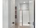 This bathroom offers a glass-enclosed shower, built in shelves, and a toilet at 113 Windy Creek Ln, Apex, NC 27502
