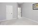 This is a well-lit bedroom featuring white doors, neutral walls, and soft carpet flooring throughout at 113 Windy Creek Ln, Apex, NC 27502