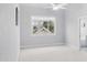 Bright bedroom featuring a ceiling fan, large window offering lots of natural light, and neutral color palette at 113 Windy Creek Ln, Apex, NC 27502