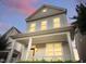Inviting two-story home with a cozy front porch, perfect for relaxing evenings at 113 Windy Creek Ln, Apex, NC 27502