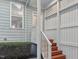 Inviting front porch with painted steps and charming lattice accents at 113 Windy Creek Ln, Apex, NC 27502