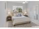 Serene main bedroom with neutral tones, large window, and a calming atmosphere at 113 Windy Creek Ln, Apex, NC 27502