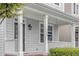 Welcoming front porch features classic columns and well-maintained landscaping at 113 Windy Creek Ln, Apex, NC 27502