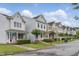 Charming street view of colorful townhomes with manicured lawns at 113 Windy Creek Ln, Apex, NC 27502