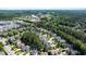 Scenic aerial view of a neighborhood with lush green trees and well-maintained homes under a blue sky at 1132 Heritage Knoll Dr, Wake Forest, NC 27587