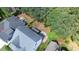 Aerial view of backyard, patio and fire pit in wooded lot at 1132 Heritage Knoll Dr, Wake Forest, NC 27587