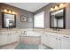 Bathroom with and vanities, granite countertops, and a center garden tub at 1132 Heritage Knoll Dr, Wake Forest, NC 27587