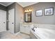 Bathroom featuring granite countertop, dual sink, vanity, and large tub at 1132 Heritage Knoll Dr, Wake Forest, NC 27587