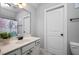 Bright bathroom with a single sink vanity, large mirror, and shower tub with a decorative curtain at 1132 Heritage Knoll Dr, Wake Forest, NC 27587