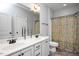 Bathroom featuring a double sink vanity, framed mirror, toilet and tub with decorative shower curtain at 1132 Heritage Knoll Dr, Wake Forest, NC 27587