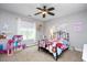 Cozy bedroom with iron bed frame, ceiling fan and lots of personalized decorations at 1132 Heritage Knoll Dr, Wake Forest, NC 27587