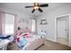 Charming bedroom featuring a plush bed, ceiling fan and a large window with natural light at 1132 Heritage Knoll Dr, Wake Forest, NC 27587