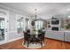 Cozy dining area with hardwood floors, chandelier, and views of the living room and sunroom at 1132 Heritage Knoll Dr, Wake Forest, NC 27587