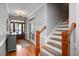 Foyer with hardwood floors, stairs, chandelier, and exterior door at 1132 Heritage Knoll Dr, Wake Forest, NC 27587